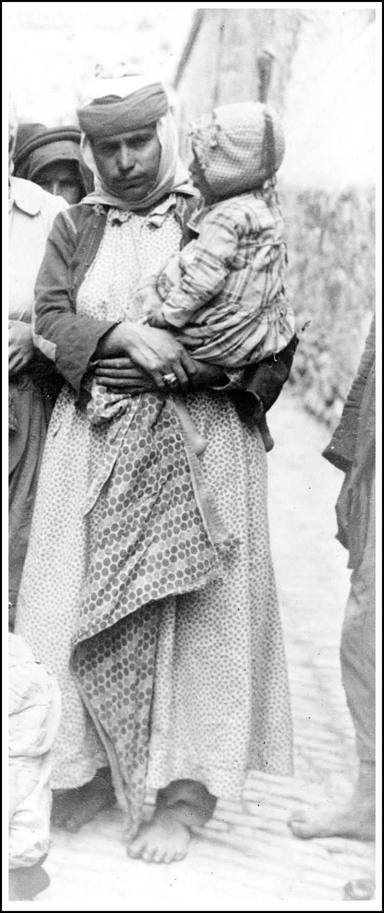 A picture containing text, person, outdoor, posing
Description automatically generated